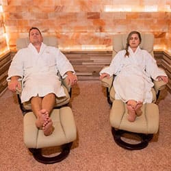 Two people relaxing at the salt room at the waldorf astoria hotel