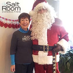Santa clause posing with the owner of the salt room woodbury minnesota